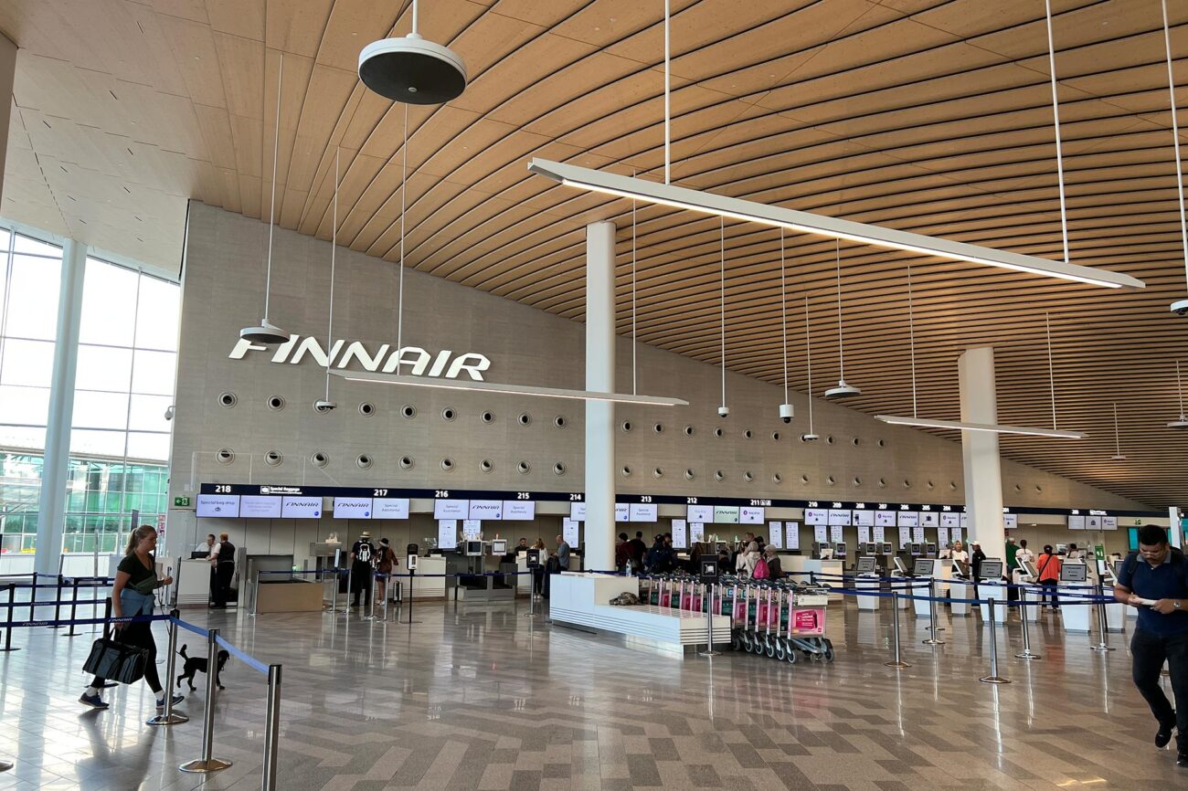 People in line in front of the check-in counters at Helsinki-Vantaa Airport.