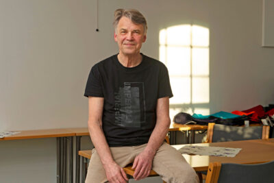 Harri Melin istuu pöydän kulmalla.